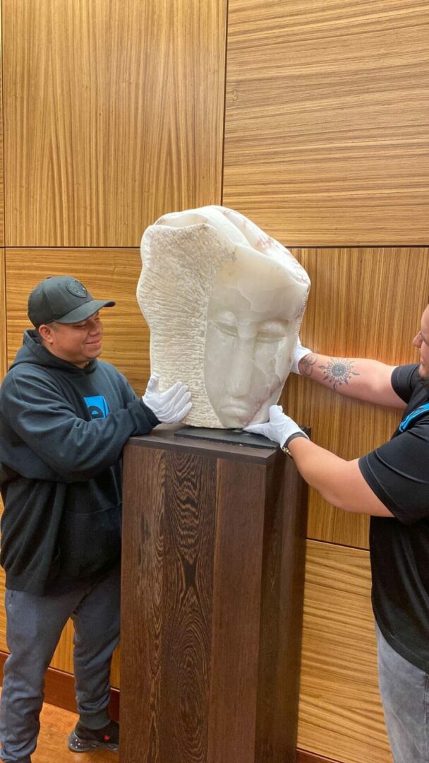 Movers handle marble statue