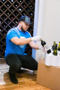 A mover packs wine bottles