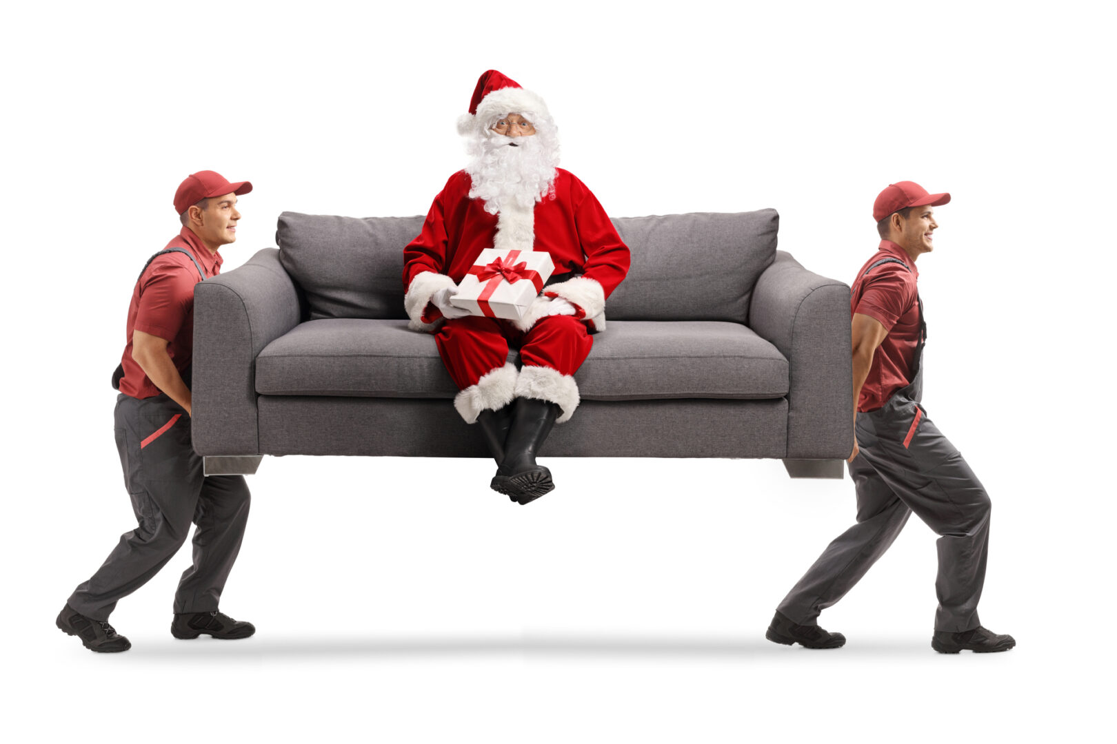 Santa sitting on a couch as 2 movers carry it off
